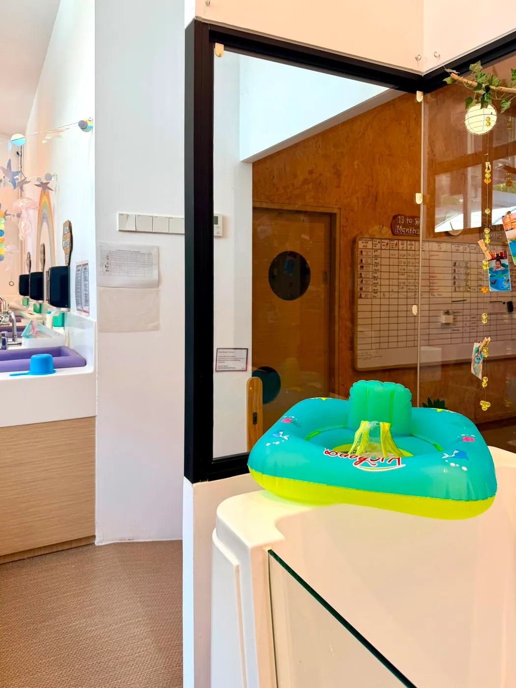An infant care routine board tracking feeds, sleep and nappy changes beside the care station